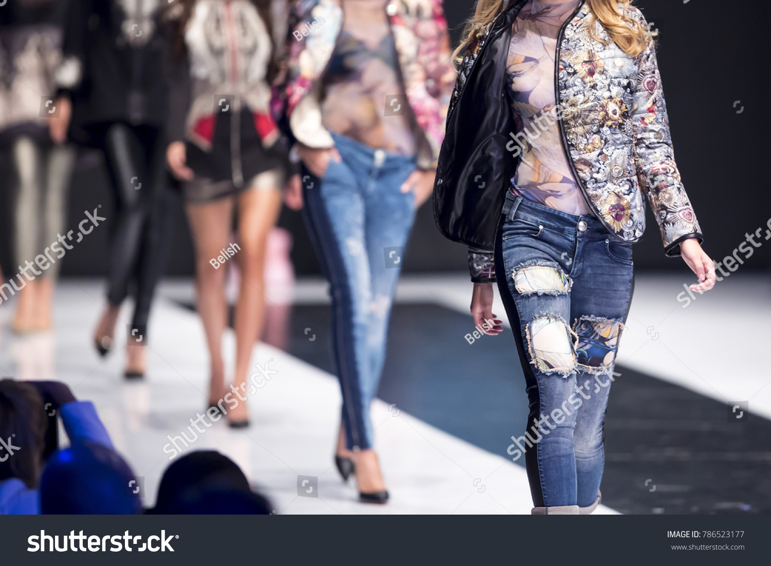 Female models walk the runway in different dresses during a Fashion Show. Fashion catwalk event showing new collection of clothes. In a row. #786523177