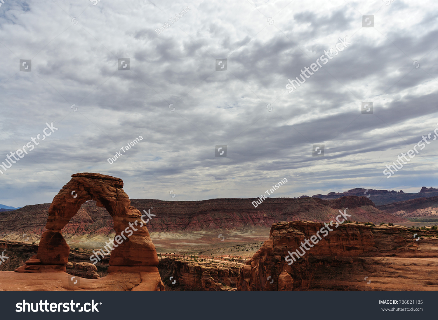 Delicate arch is a key feature, one of the largest stone arches in Arches National Park, Utah, USA. This image is from a slightly cloudy late august afternoon.  #786821185