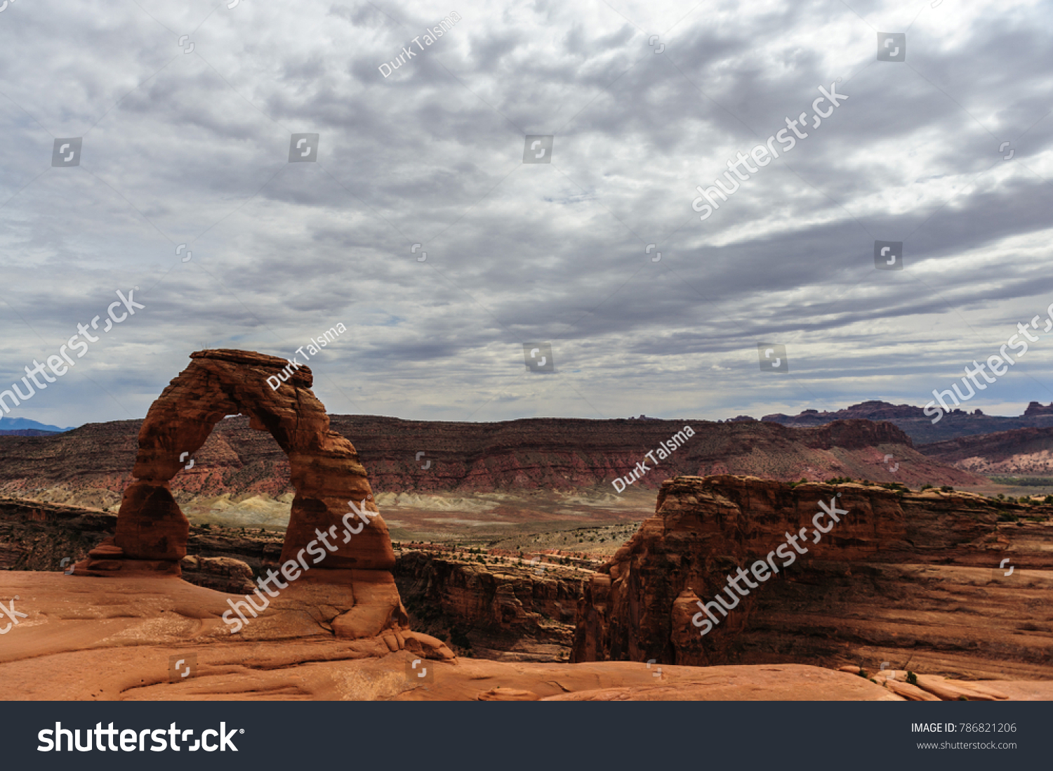 Delicate arch is a key feature, one of the largest stone arches in Arches National Park, Utah, USA. This image is from a slightly cloudy late august afternoon.  #786821206