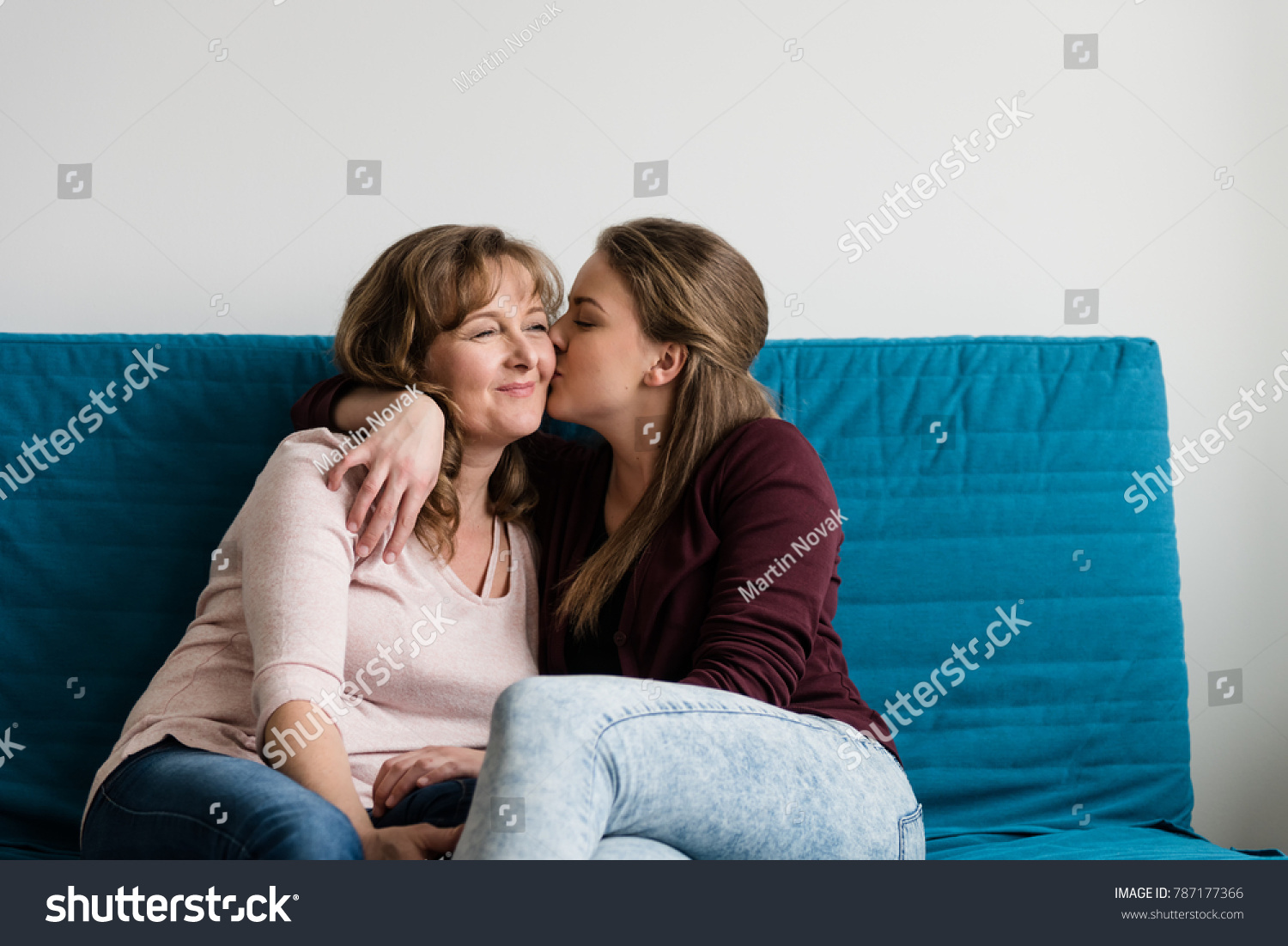 Loving mother being kissed by her affectionate daughter #787177366