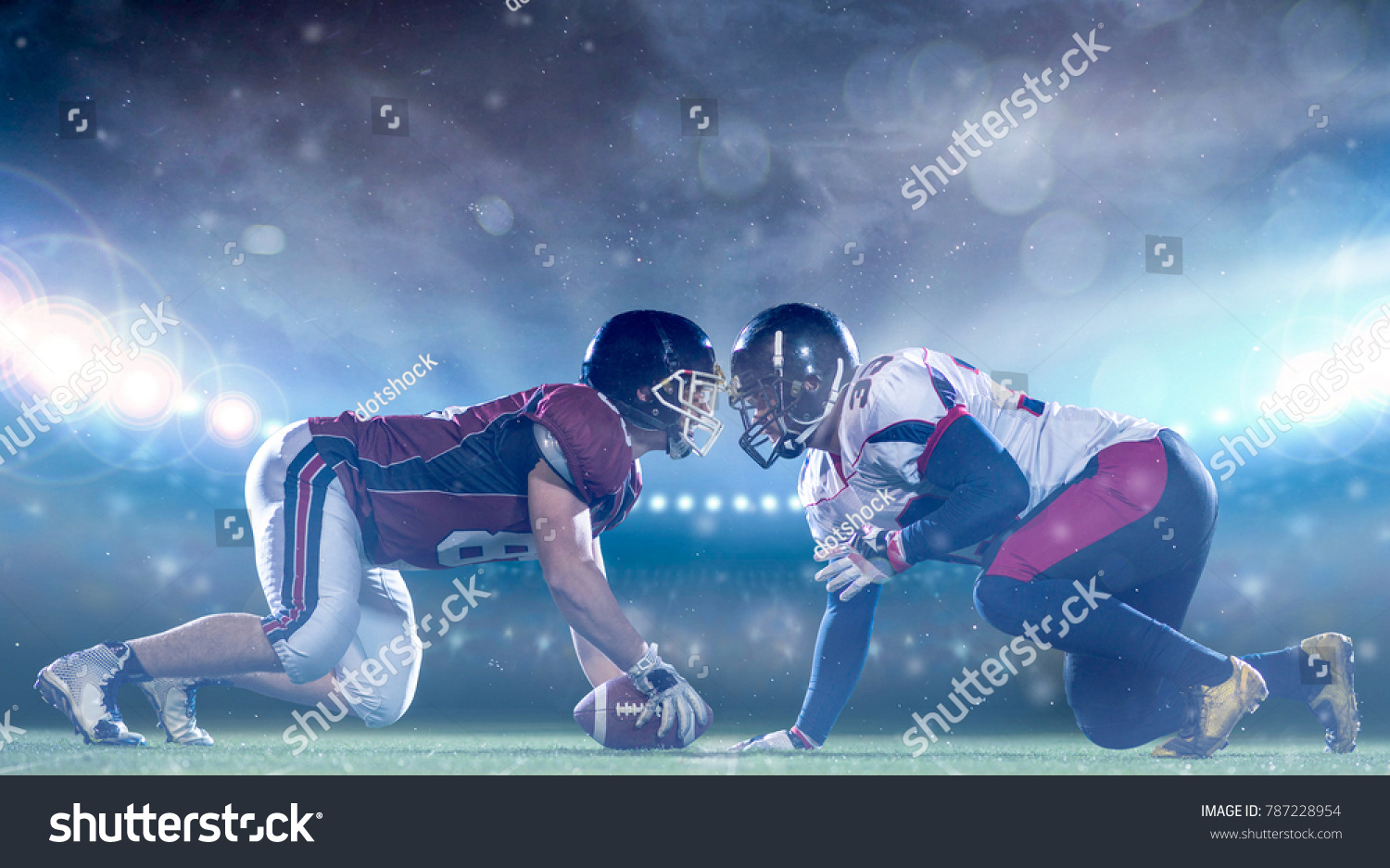 american football players are ready to start a match on modern field at night #787228954