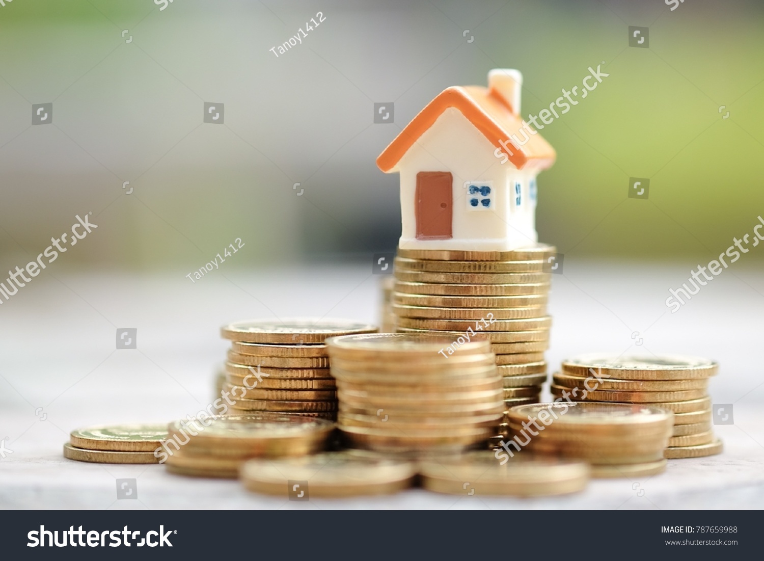 Mini house on stack of coins. Concept of Investment property. #787659988