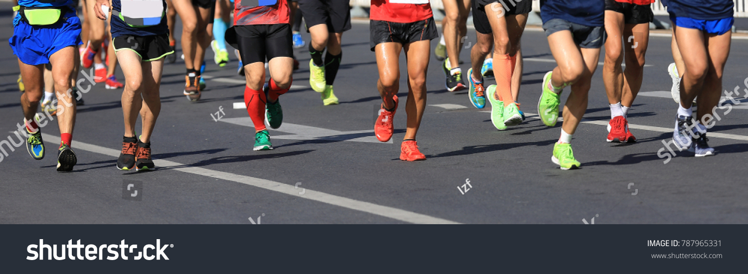 marathon runners legs running on city road #787965331