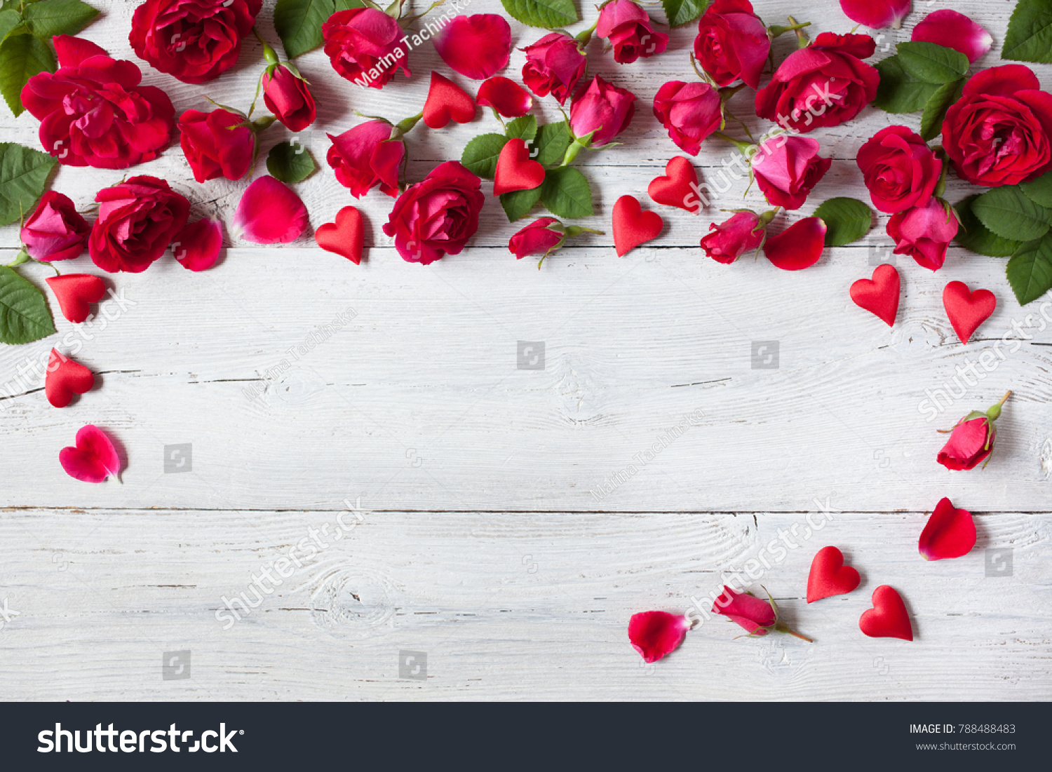 Roses and red hearts on a wooden background #788488483