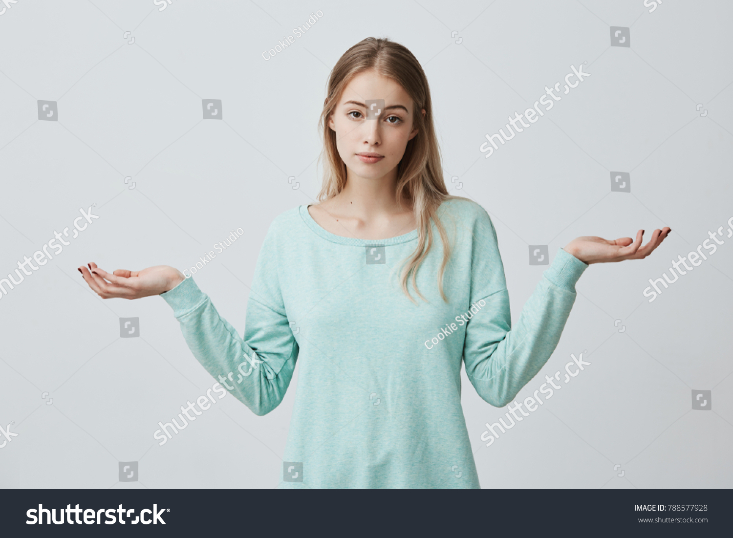 So what, Who cares. Unsure doubtful puzzled european woman with blonde dyed hair shrugging her shoulders in questioning gesture of uncertainty and having confused clueless look #788577928