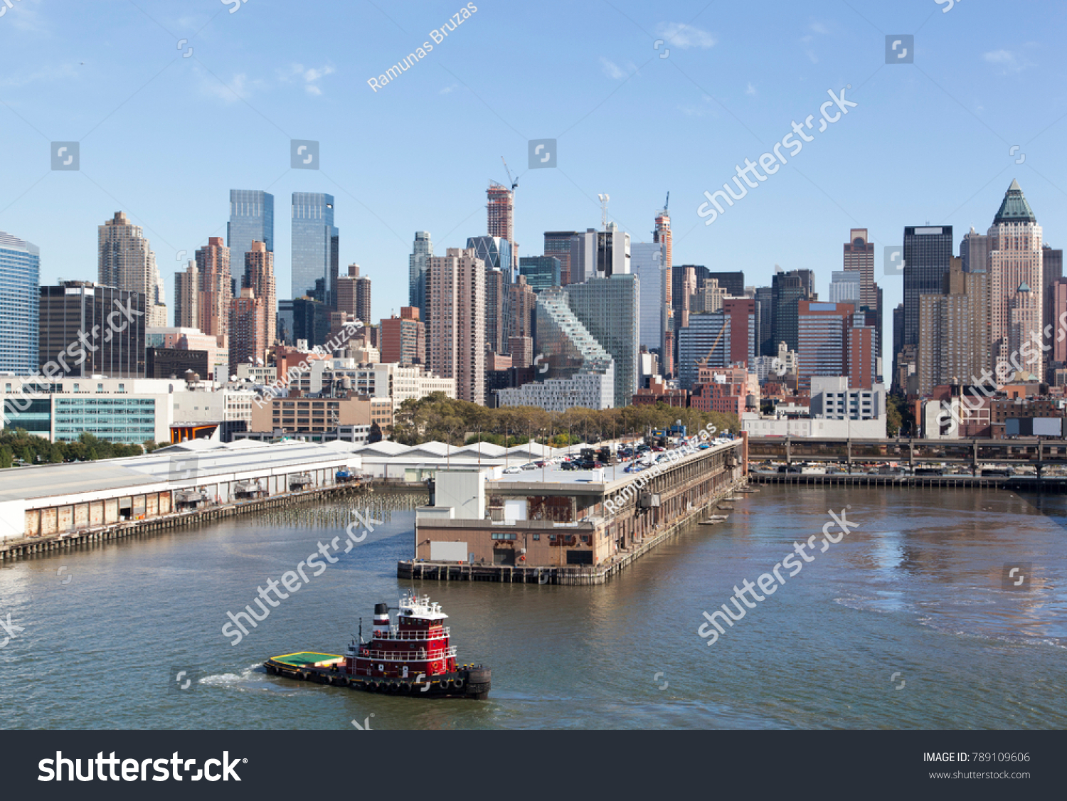 The tugboat passing by Manhattan Midtown piers (New York City). #789109606