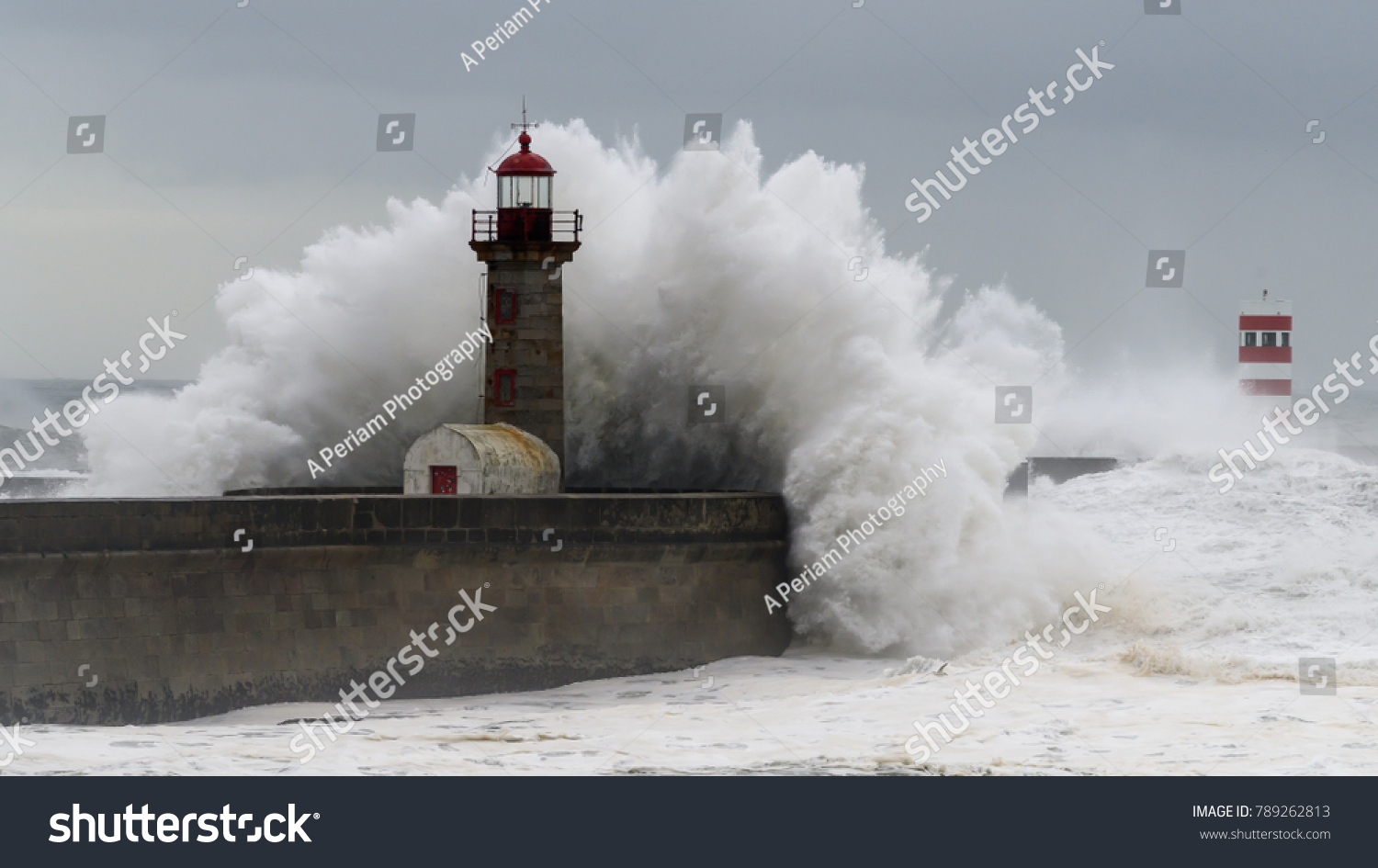 Waves crashing over a lighthouse #789262813