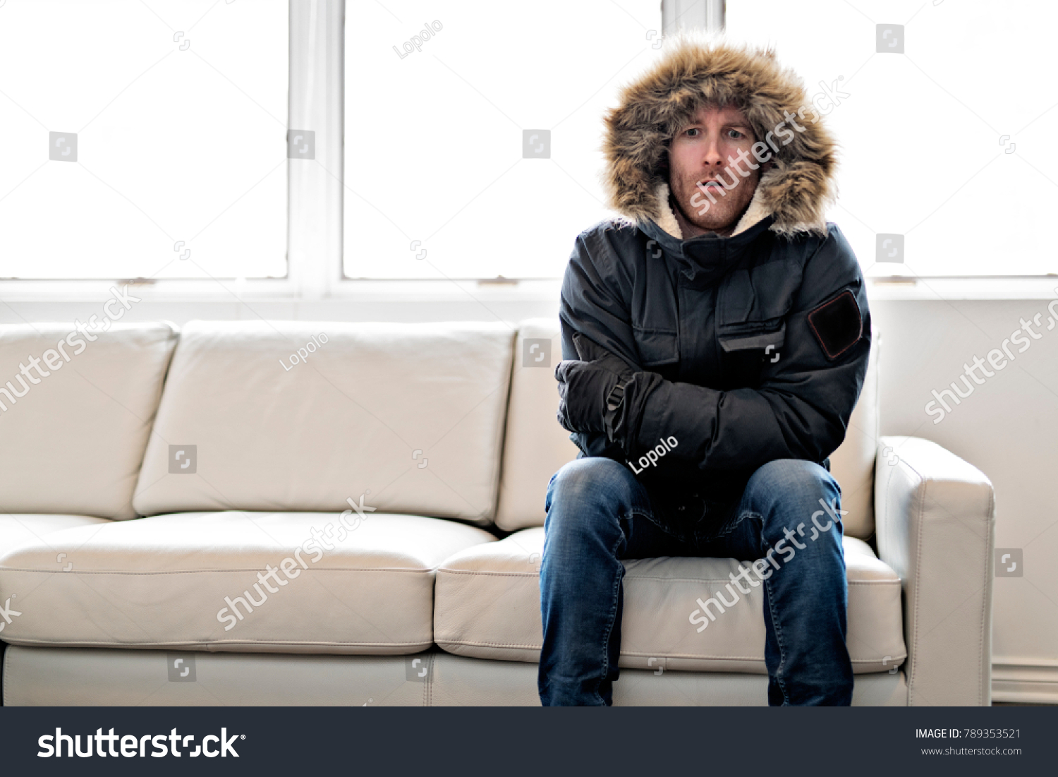 Man With Warm Clothing Feeling The Cold Inside House on the sofa #789353521