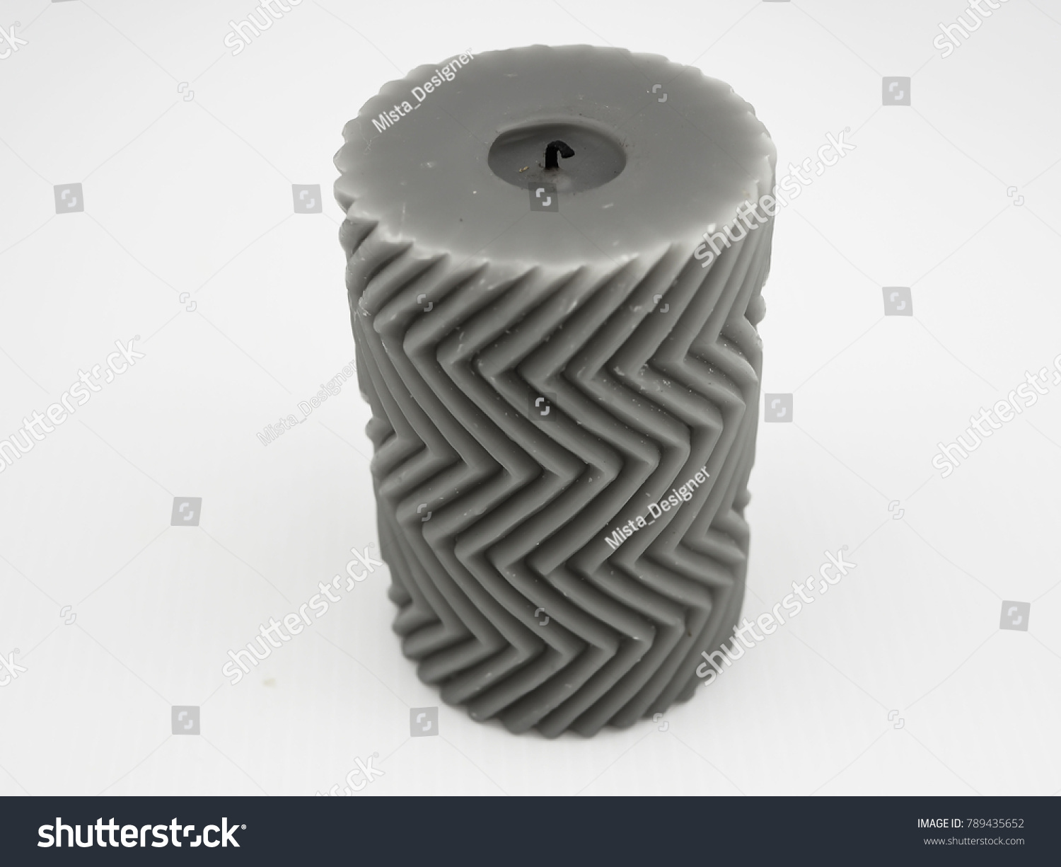 Gray decorated candle with zigzag pattern #789435652