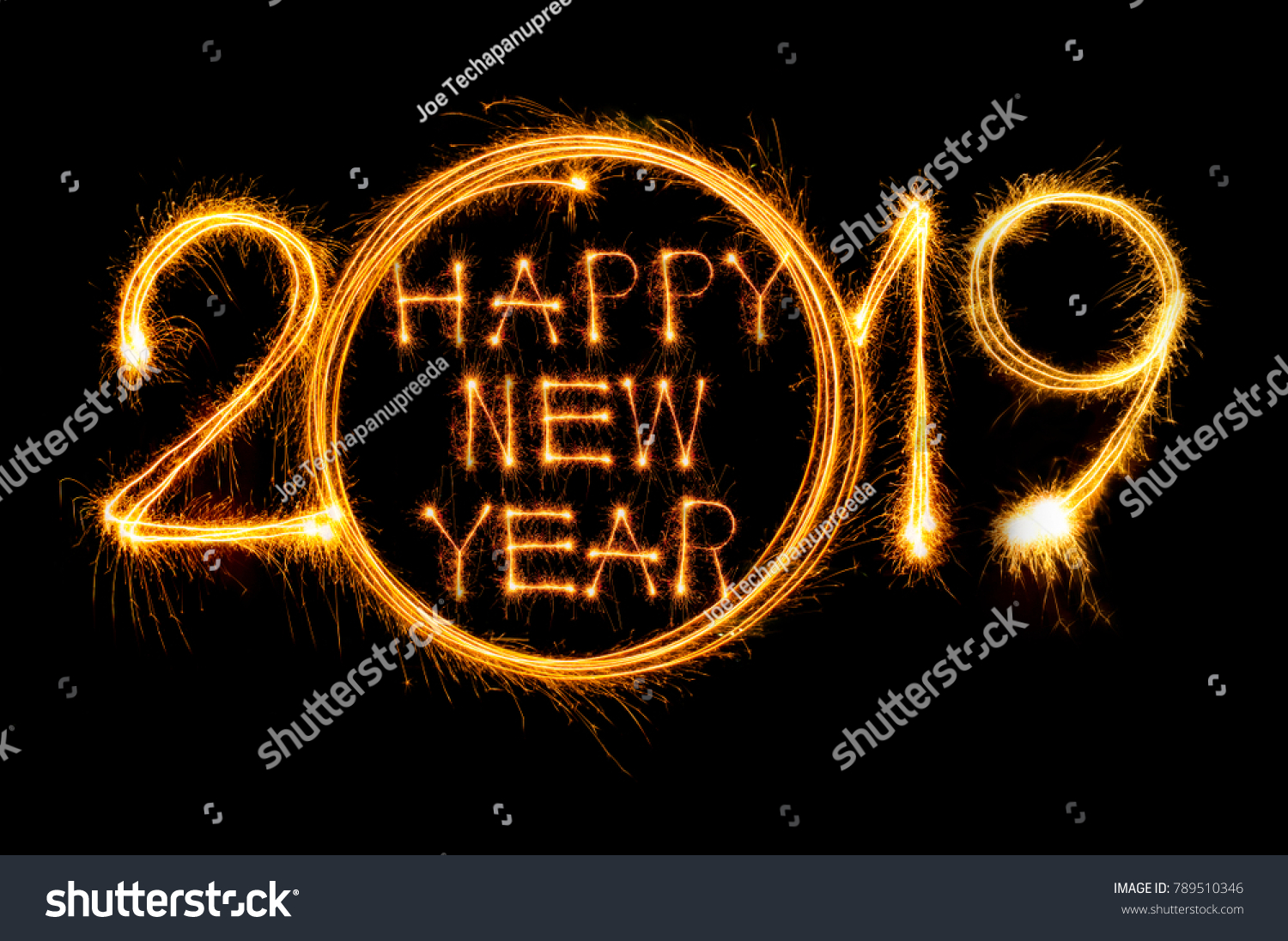 Happy new year 2019 text written with Sparkle fireworks isolated on black background #789510346