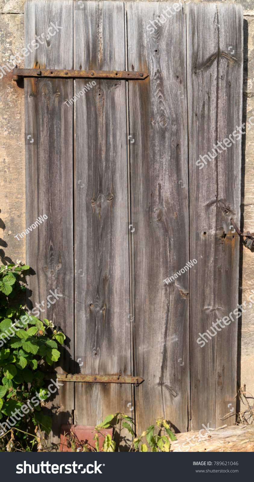 Old wood on a historical plank door on a german barnyard #789621046
