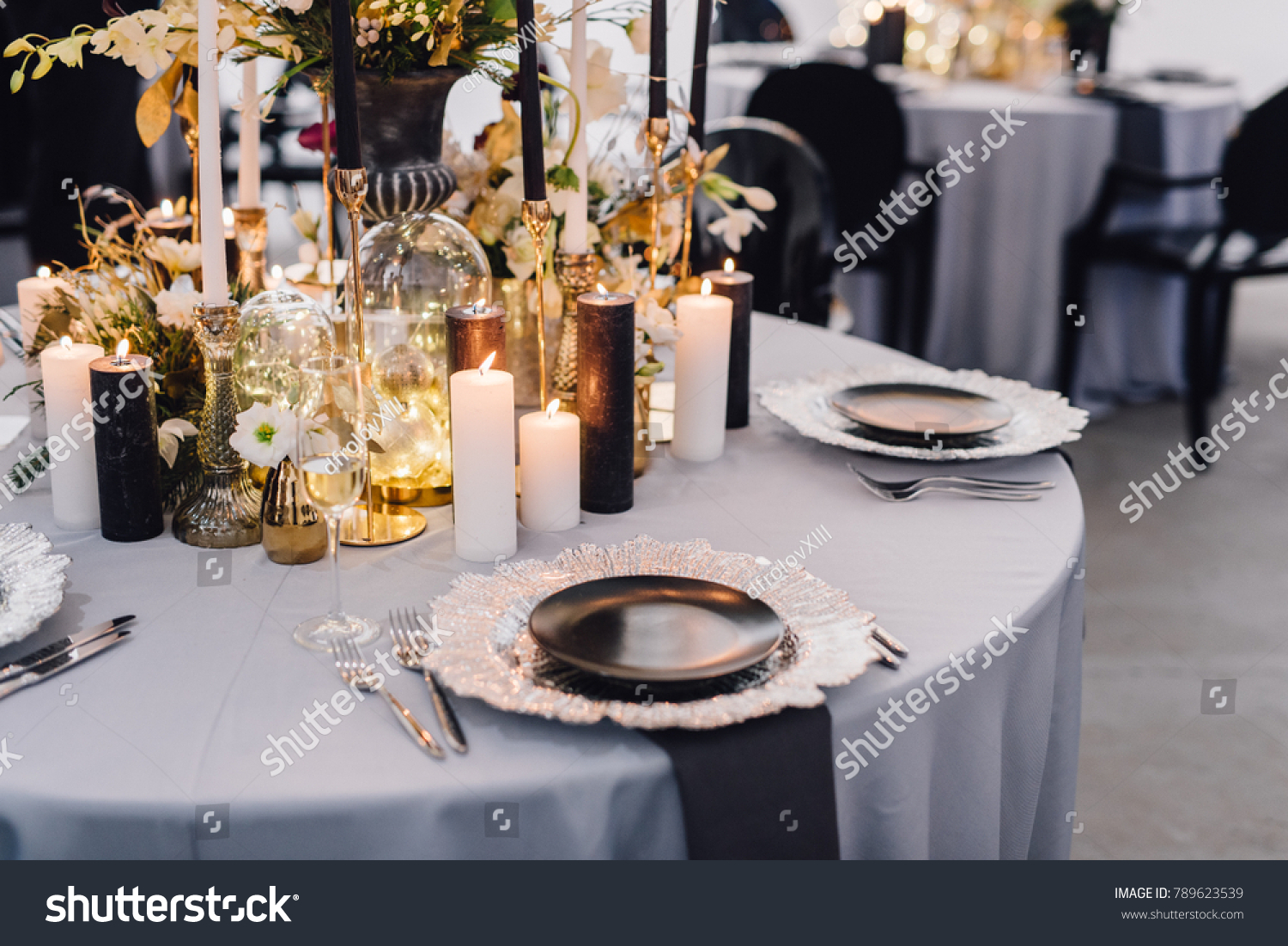 Dinner table decorated by candles and flowers. Wedding. Decor #789623539