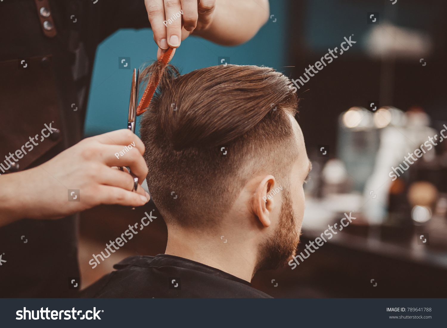 Close-up, master hairdresser does hairstyle and style with scissors and comb. Concept Barbershop. #789641788