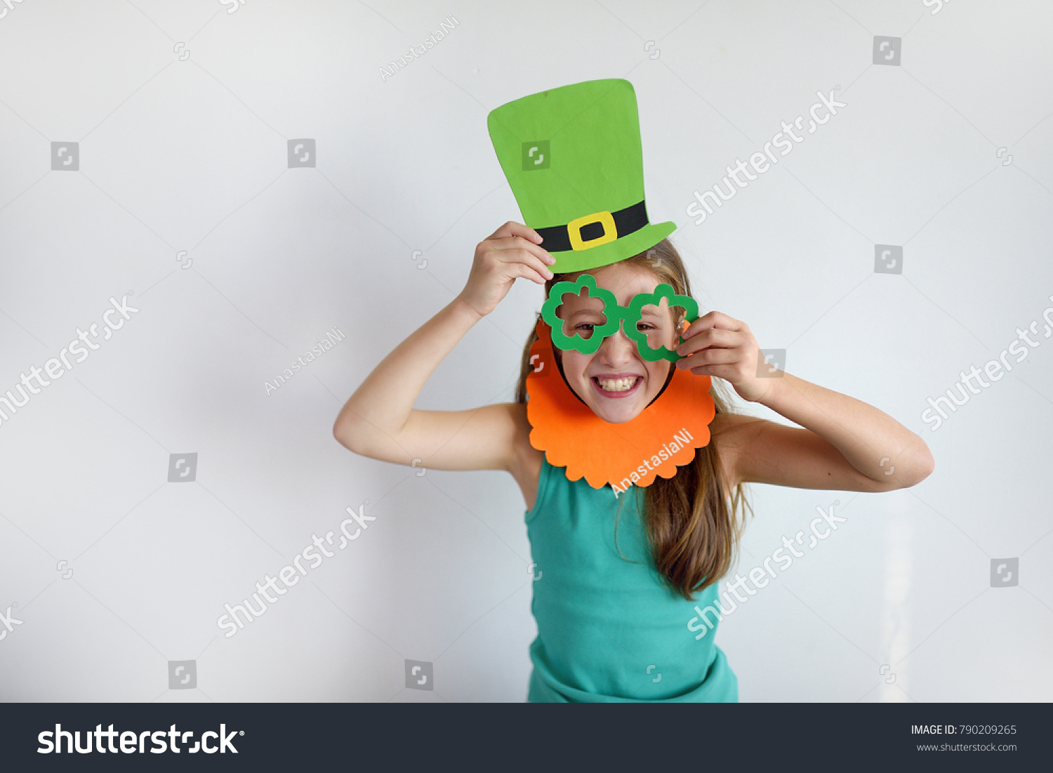 The cute girl in a mask of a leprechaun for a St. Patrick's Day #790209265