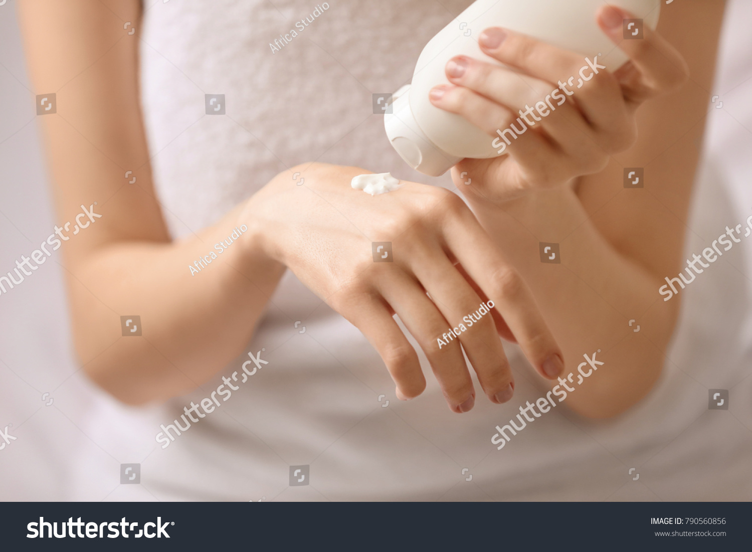 Young woman applying hand cream, closeup #790560856