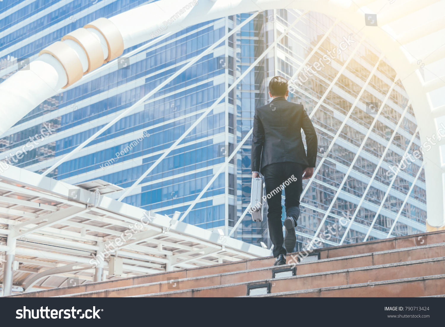 Young businessman walking in city for going to work with cityscape background. #790713424