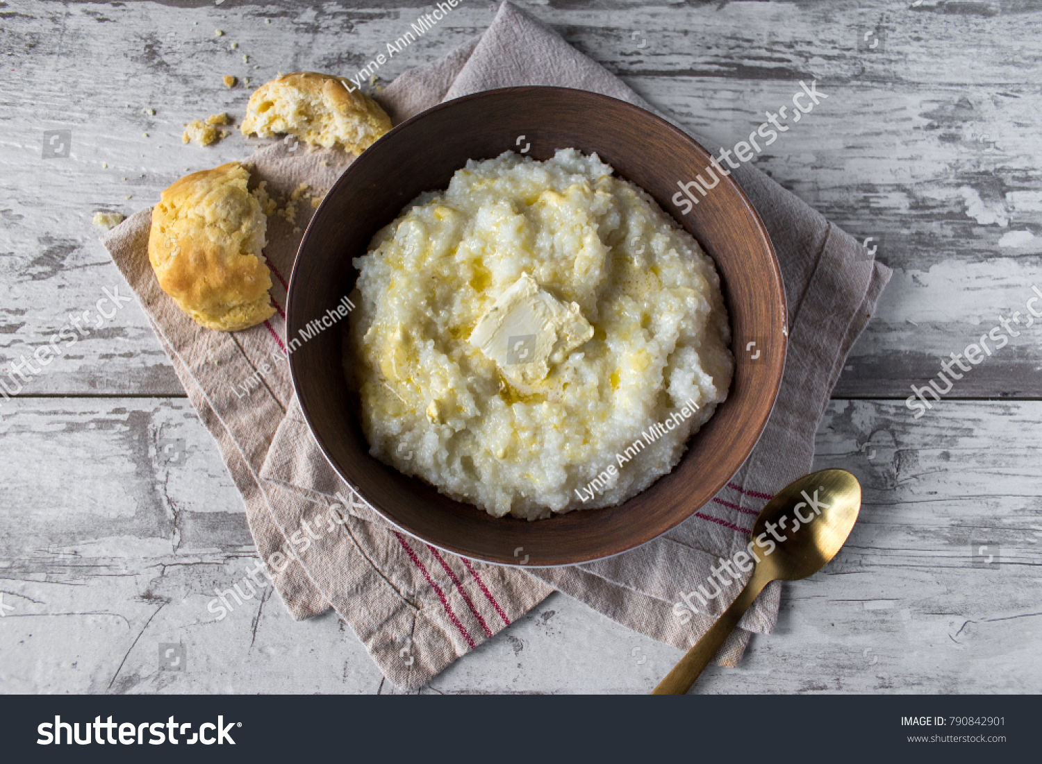 buttered grits with biscuits in rustic setting top view #790842901