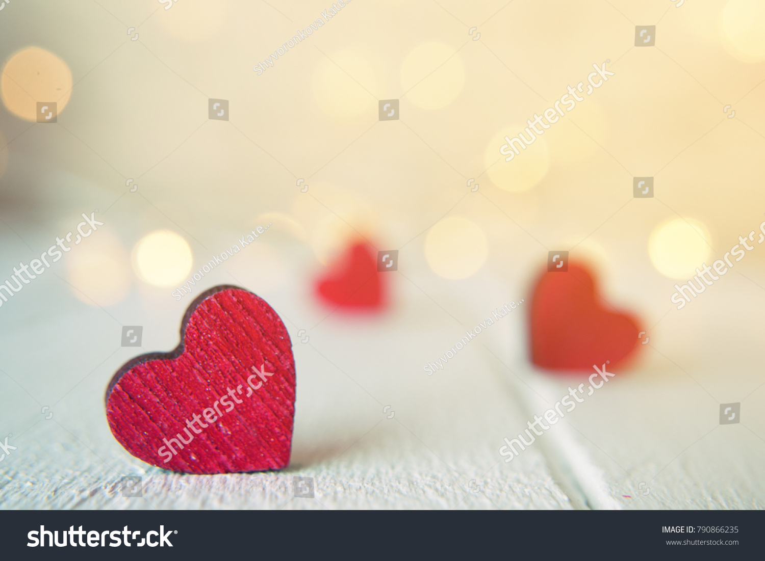 Close up of red hearts on wooden table against defocused lights. St. Valentine's Day background #790866235