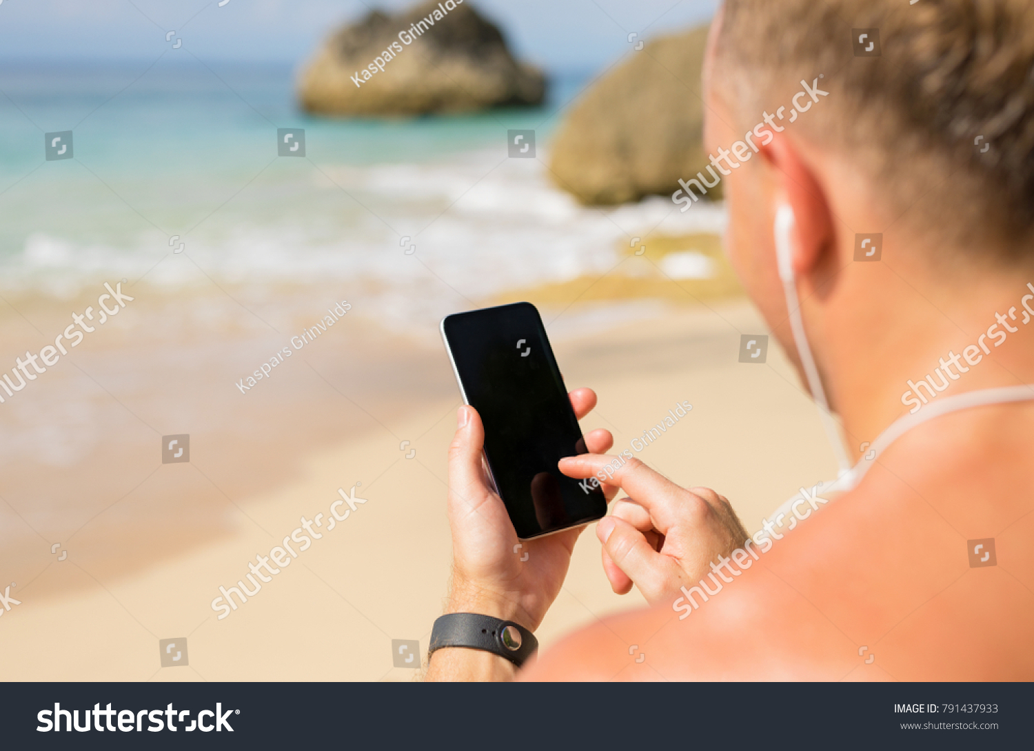 Man using phone on the beach #791437933