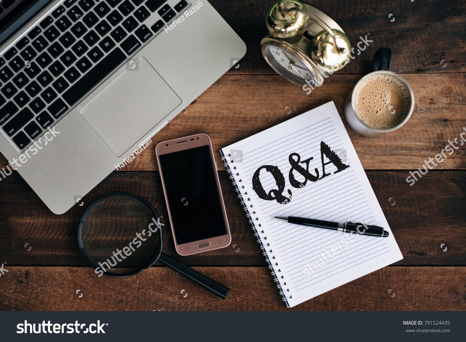 laptop, clock, phone, magnifying glass, coffee and notebook with Q&A word. Questions and answer concept #791524435