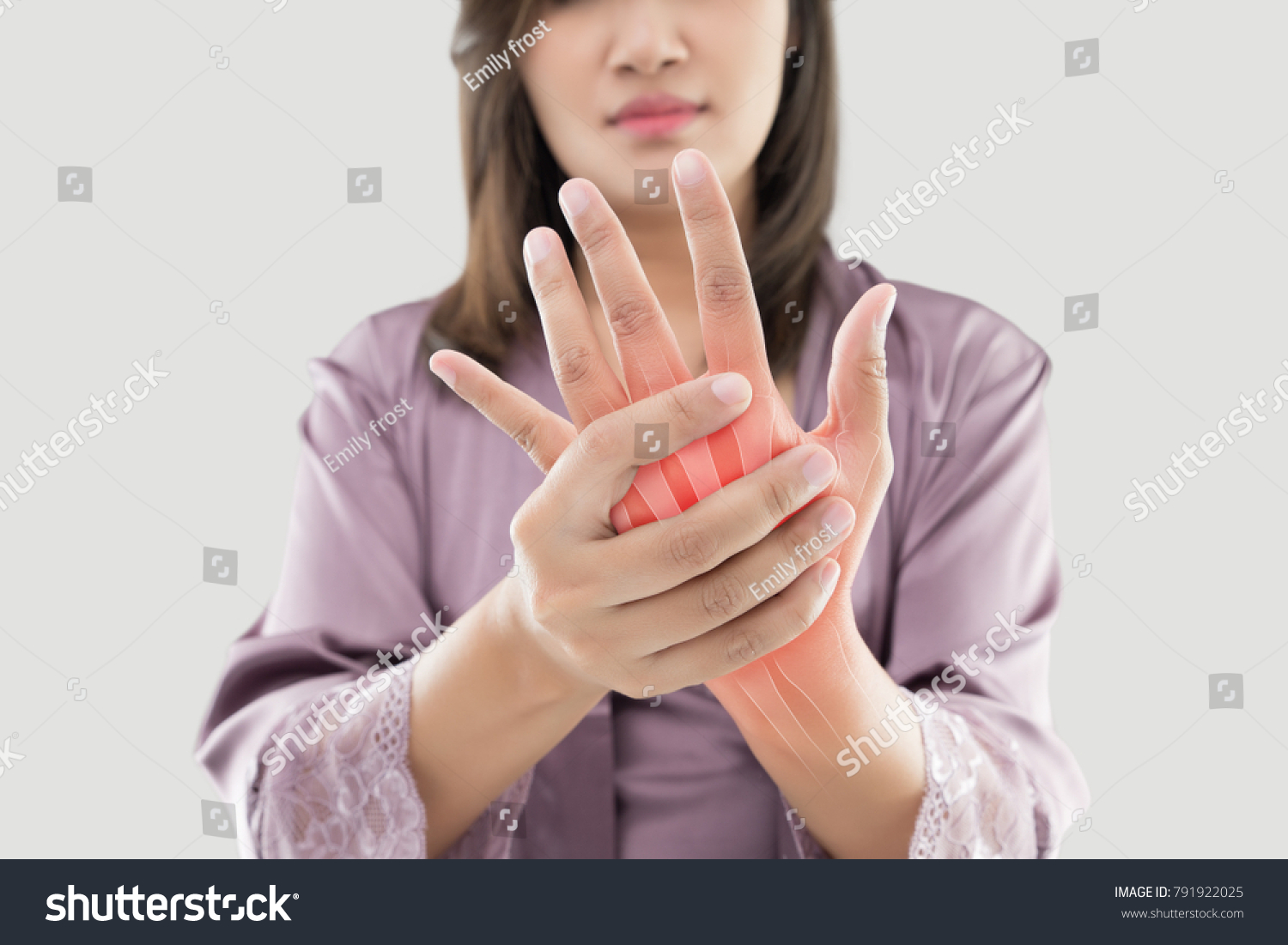 Asian woman suffering from pain in bone against gray background, Concept with hand arthritis grimace in pain #791922025
