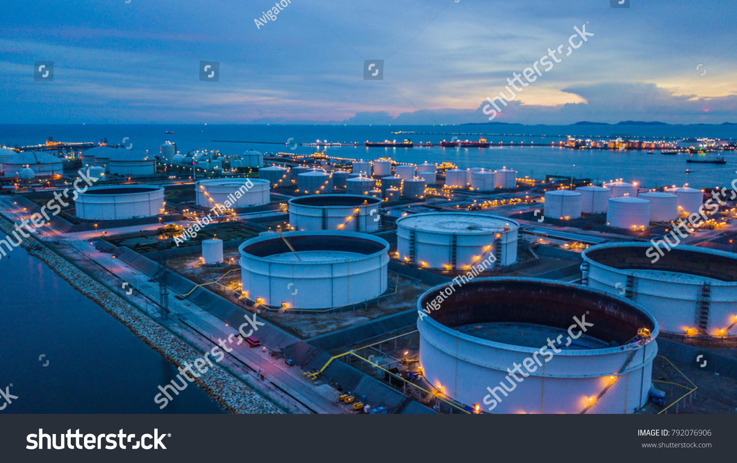 Aerial view storage tank farm at night, Tank farm storage chemical petroleum petrochemical refinery product at oil terminal, Business commercial trade fuel and energy transport by tanker vessel. #792076906
