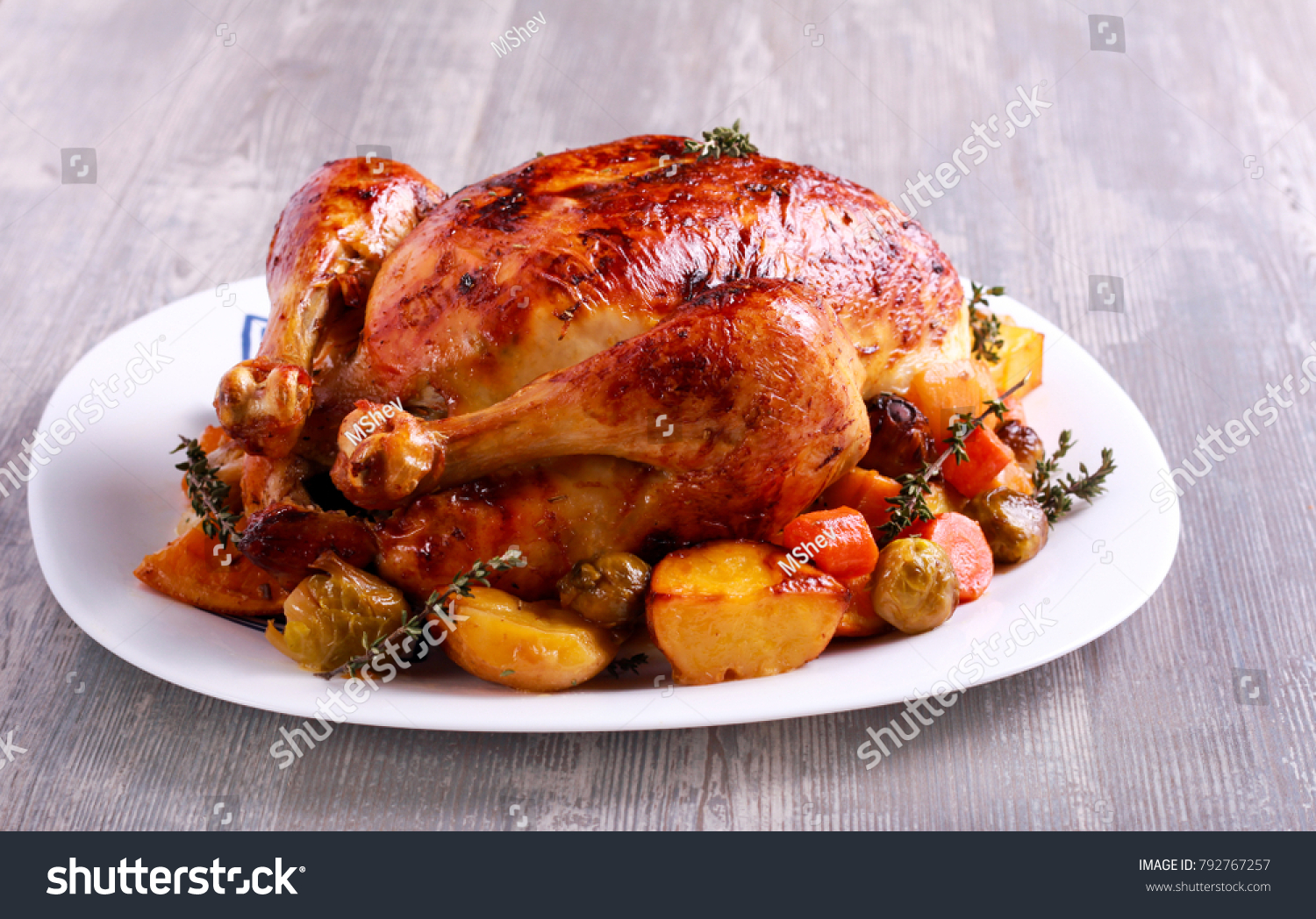Roast chicken with brussel sprouts, carrot and potato #792767257