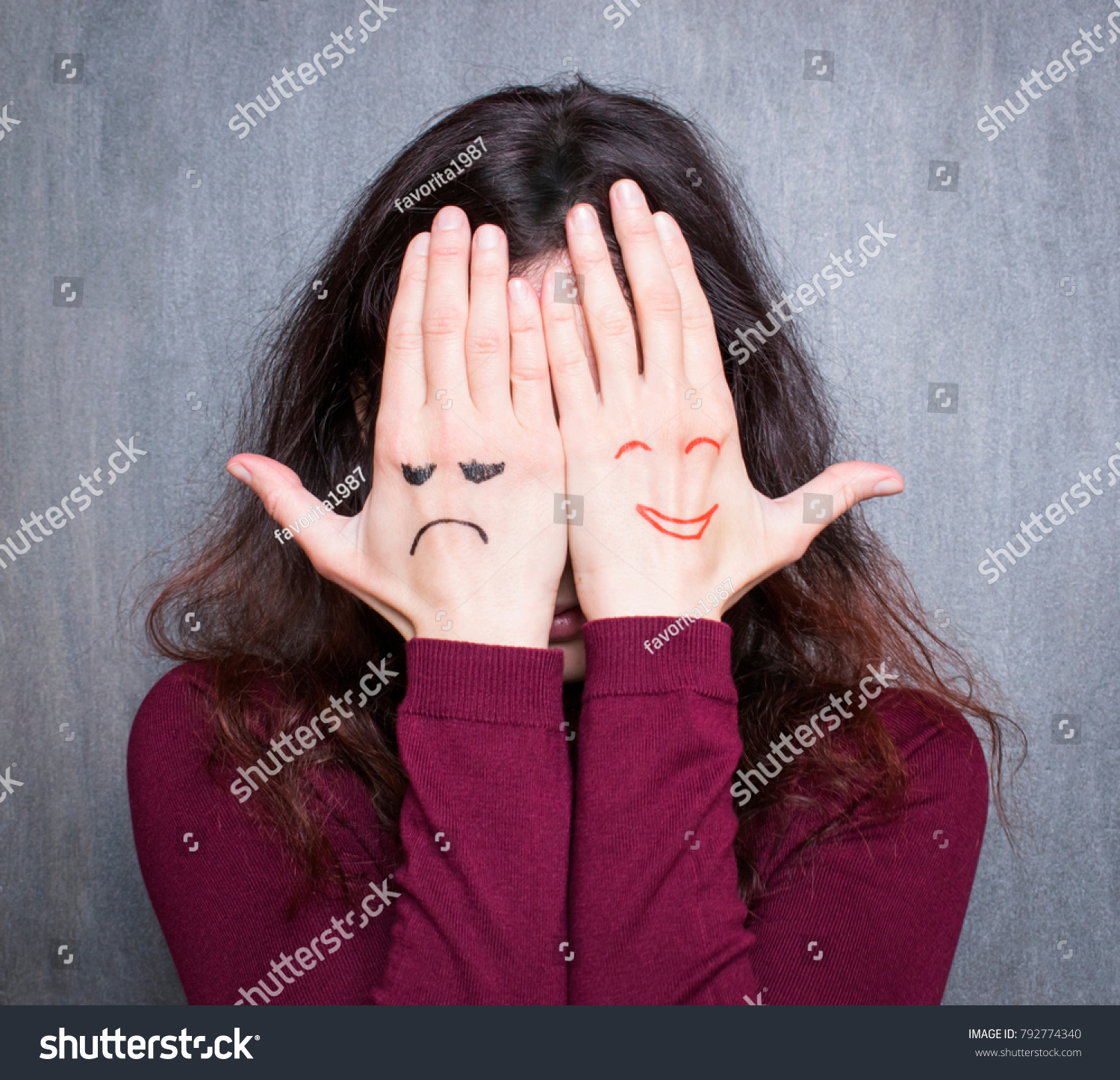 Different states of mood, woman covering her face with hands with drawn happy and sad  #792774340