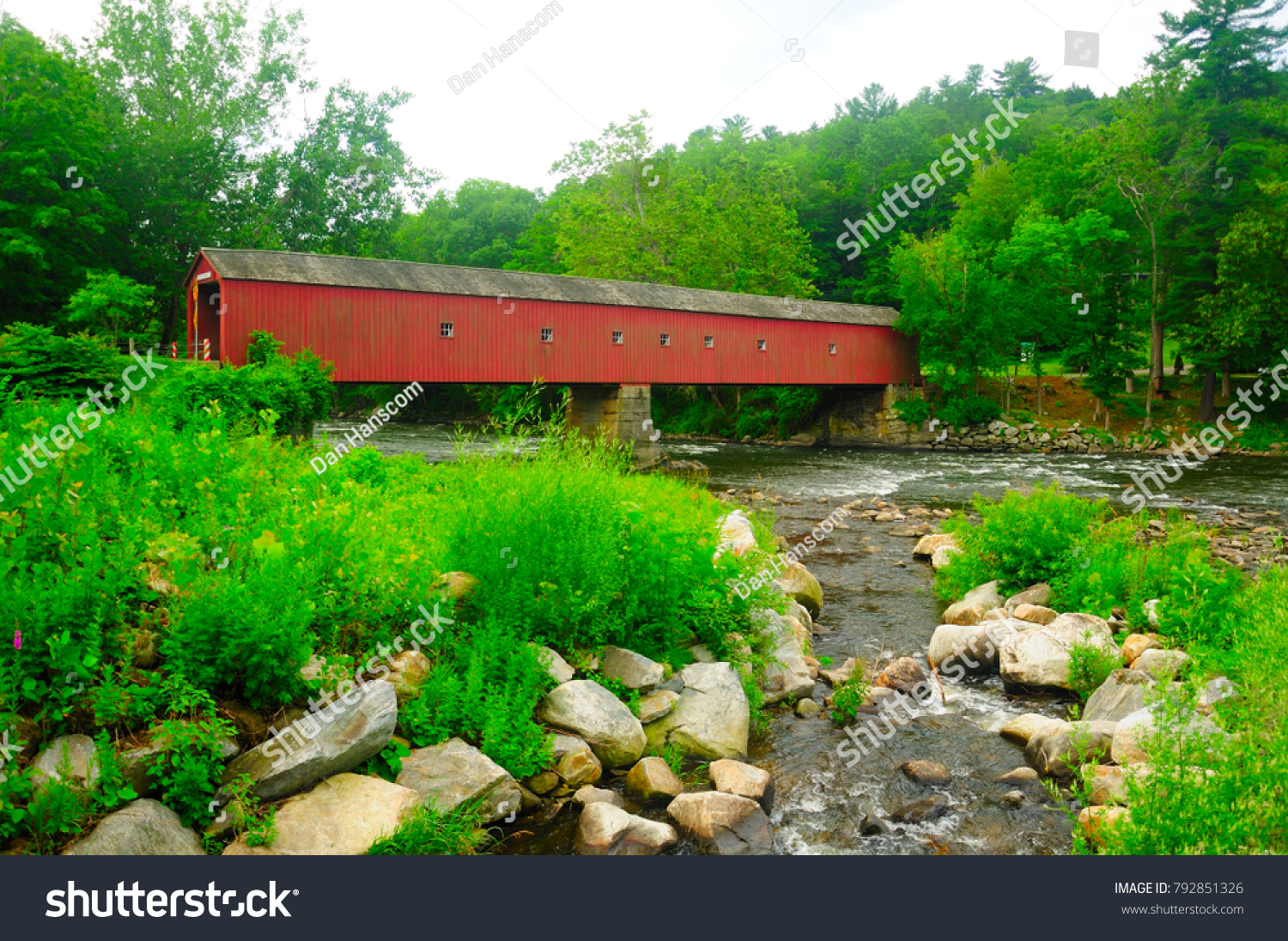 The landmark West Cornwall covered bridge over the Housatonic River in West Cornwall Connecticut in the summer.   #792851326
