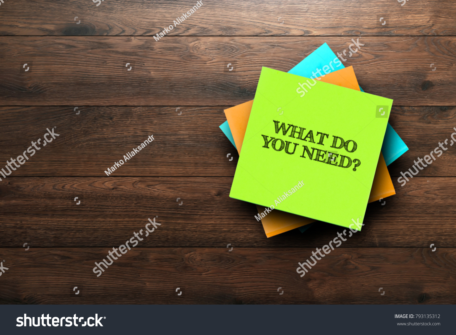 What Do You Need, the phrase is written on multi-colored stickers, on a brown wooden background. Business concept, strategy, plan, planning. #793135312
