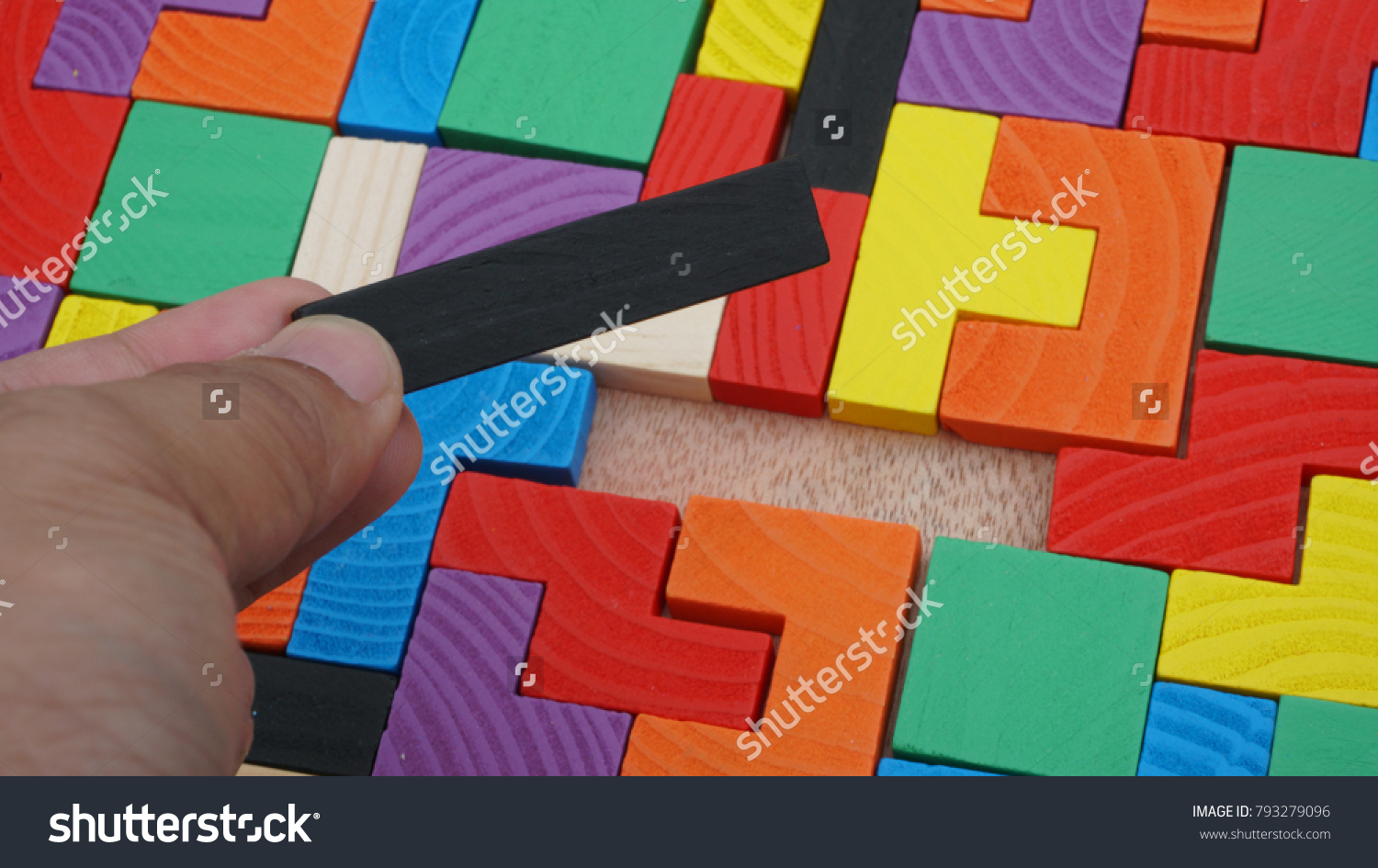 Selective focus of multicolored wooden jigsaw bricks relating to problem solving at early stage of education #793279096