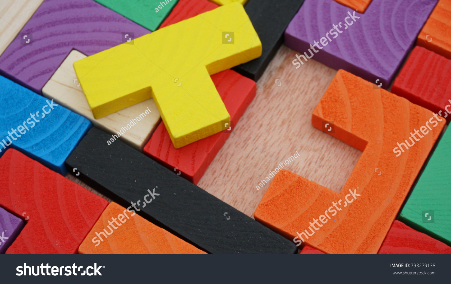 Selective focus of multicolored wooden jigsaw bricks relating to problem solving at early stage of education #793279138