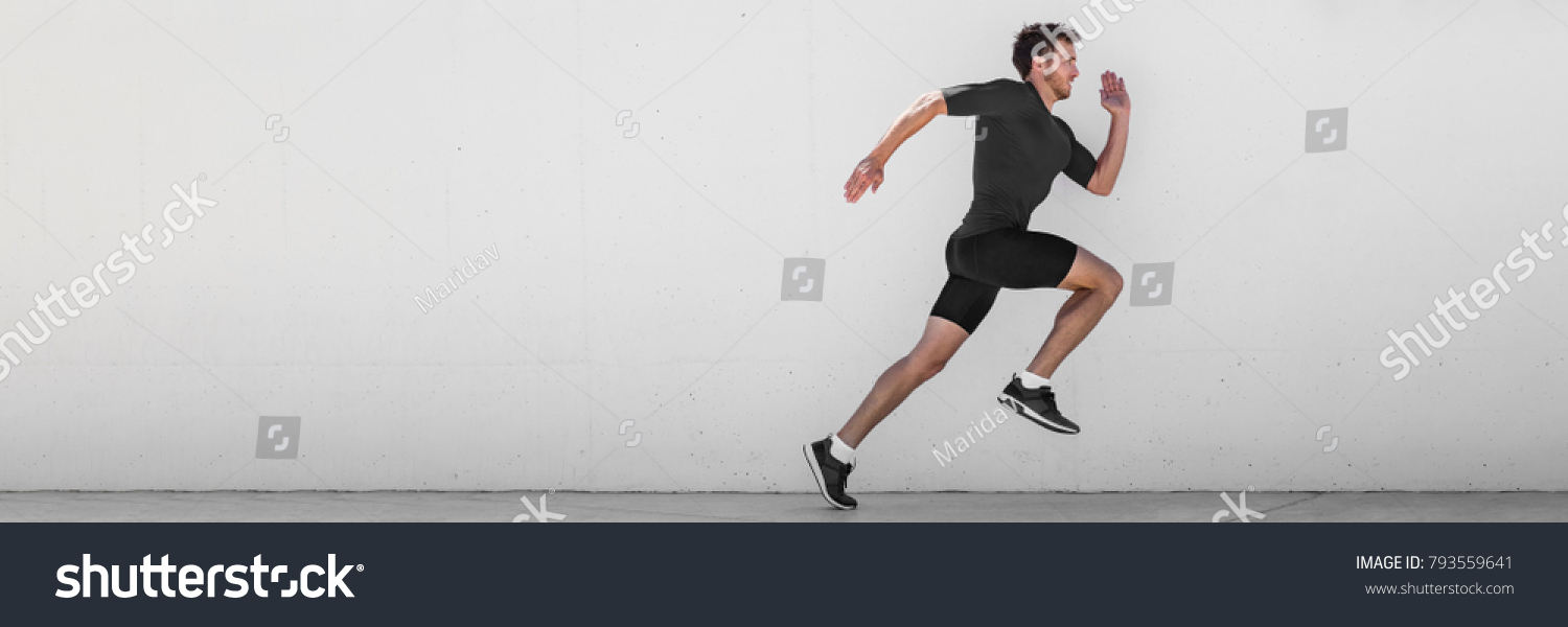 Running man runner training doing outdoor city run sprinting along wall background. Urban healthy active lifestyle. Male athlete doing sprint hiit high intensity interval training. Banner panorama. #793559641