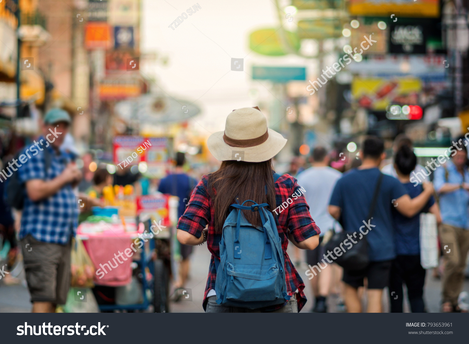 Back side of Young Asian traveling women walking and looking in Khaosan Road walking street in evening at Bangkok, Thailand, traveler and tourist concept #793653961