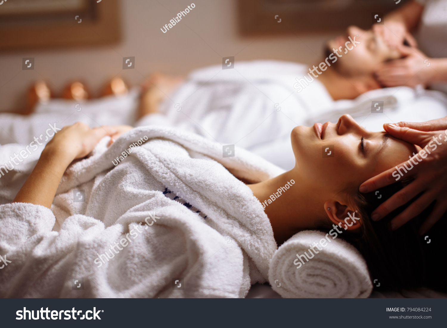 Young couple receiving head massage at beauty spa #794084224
