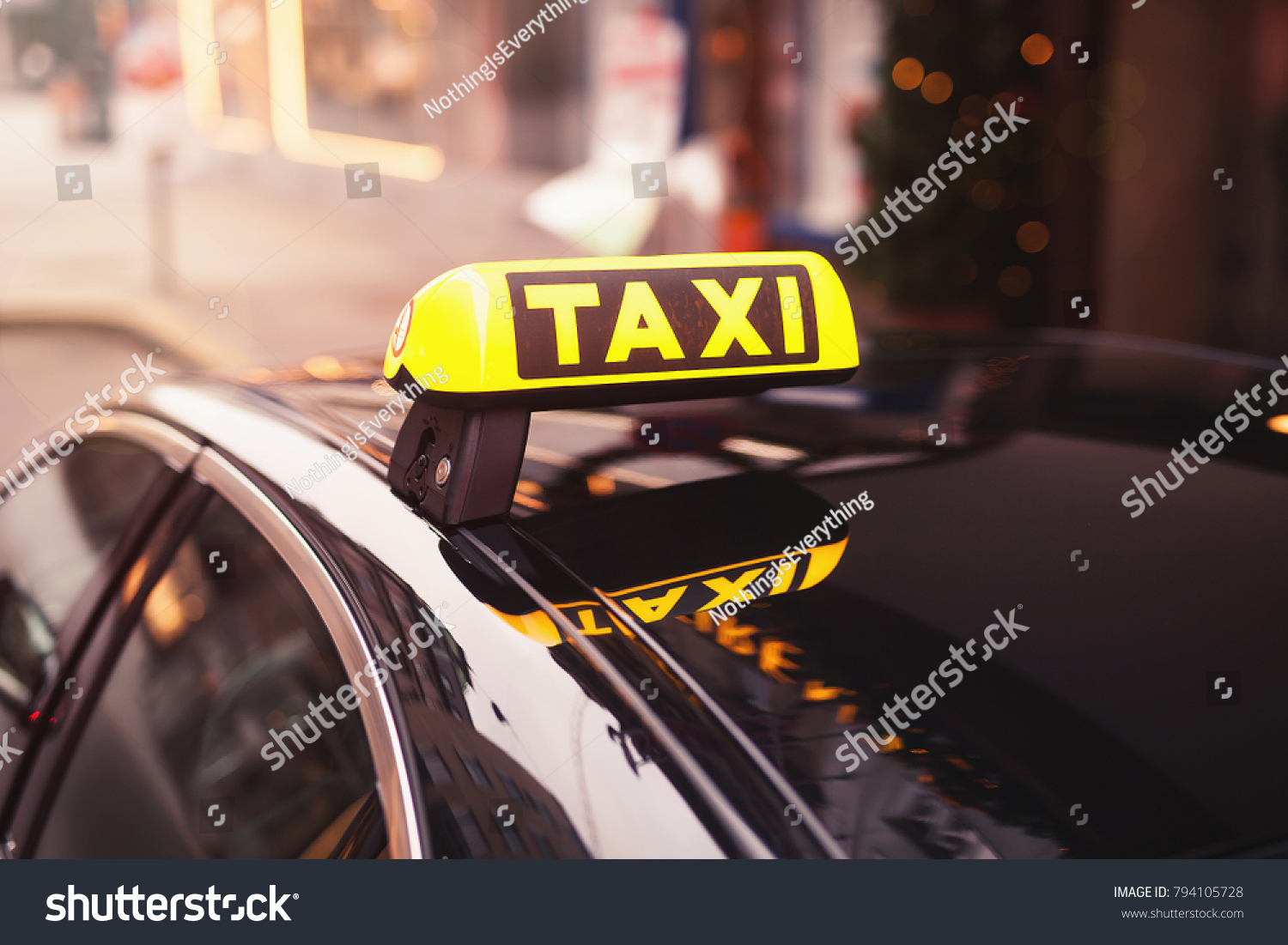 yellow taxi car roof sign at night. taxi car on the street at night. selective focused image. #794105728