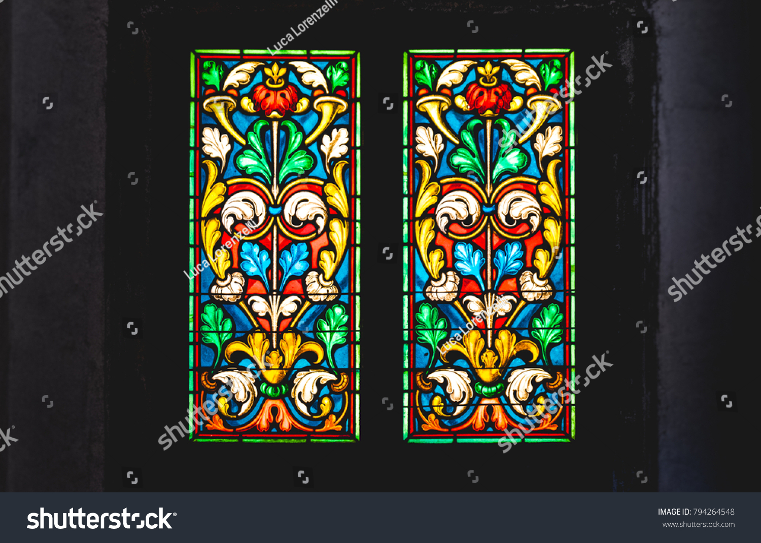 coloured stained glass window colored in a dark background church #794264548