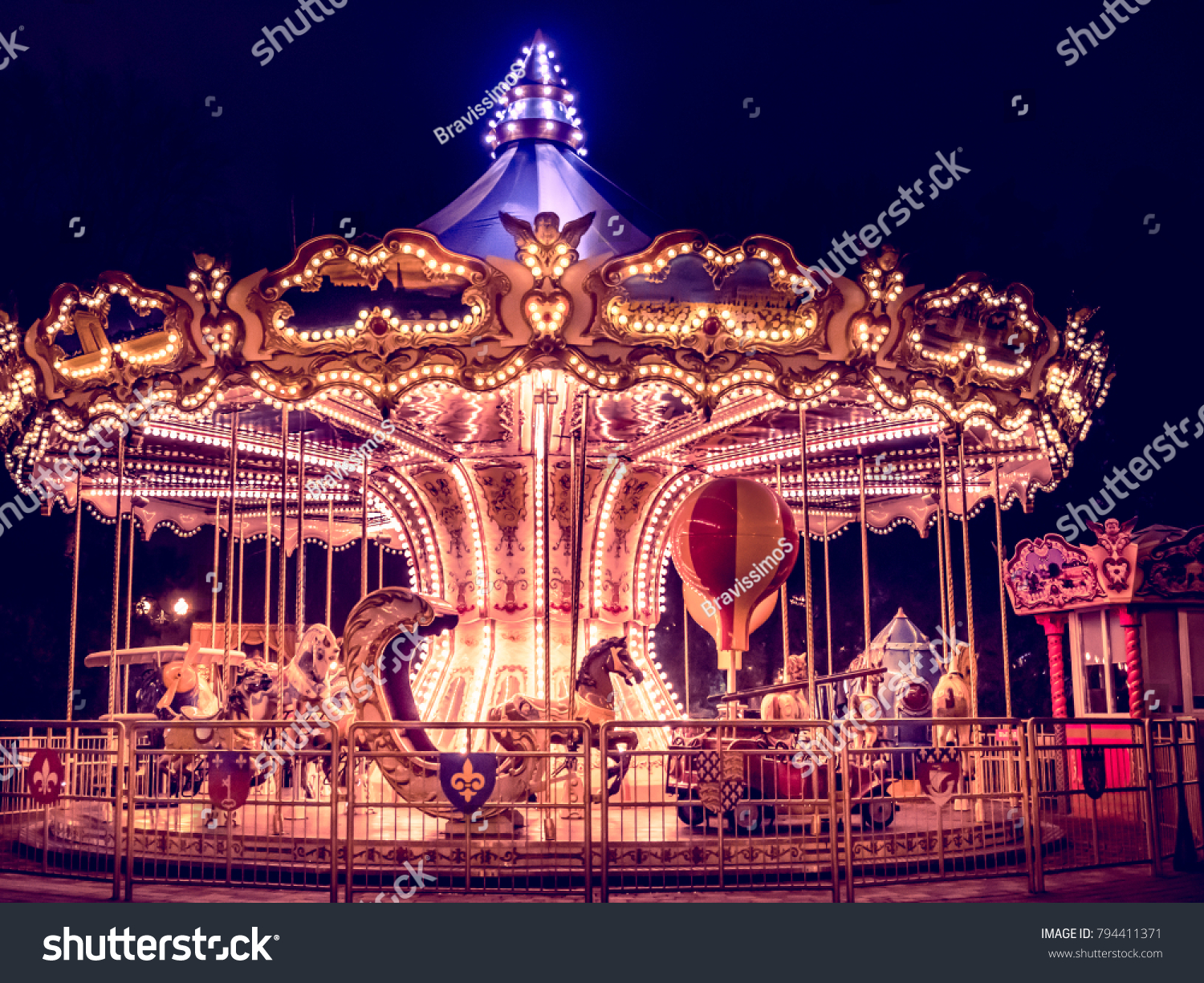 beautiful bright carousel in park at night in winter #794411371