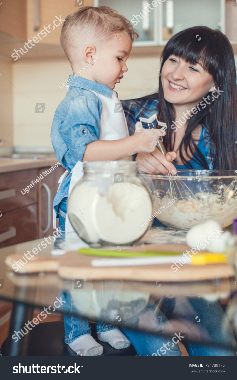 mother whisking dough and son holding dough mold #794789176
