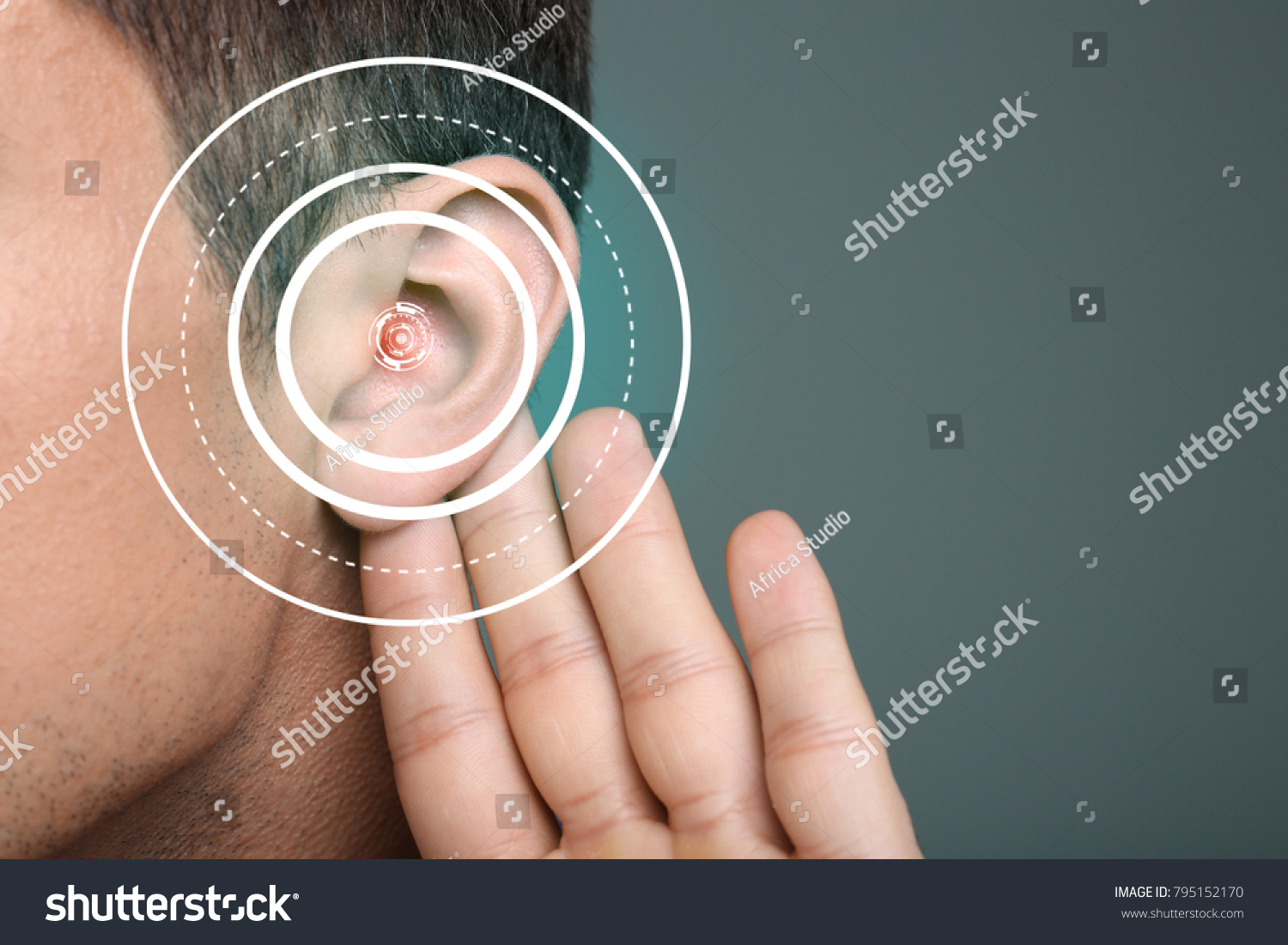 Young man with symptom of hearing loss on color background #795152170