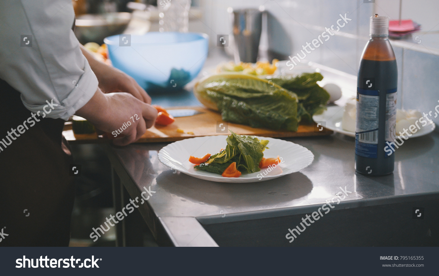 Male chef preparing salad in commercial kitchen #795165355