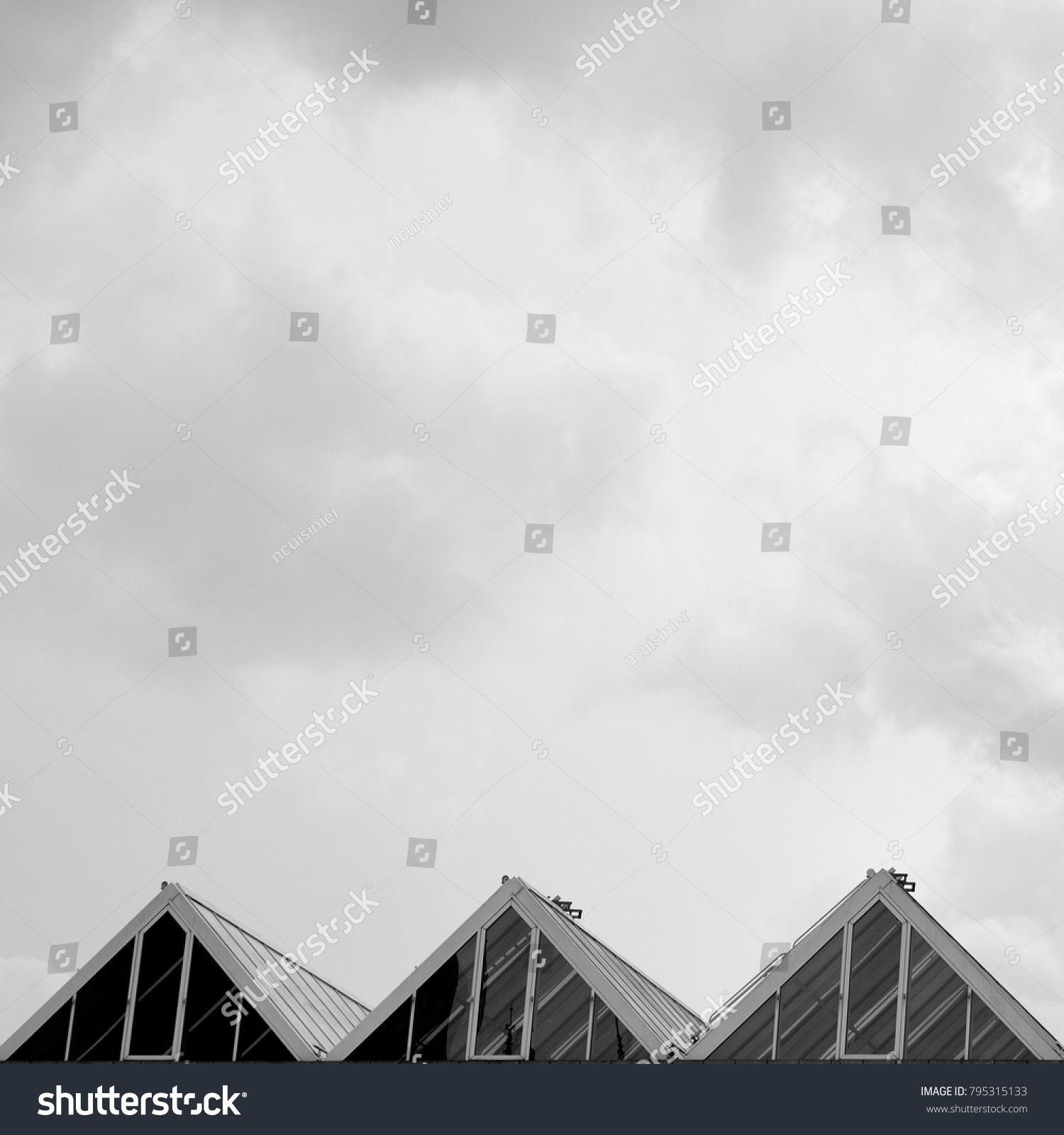 three triangles, cloudy sky in background #795315133