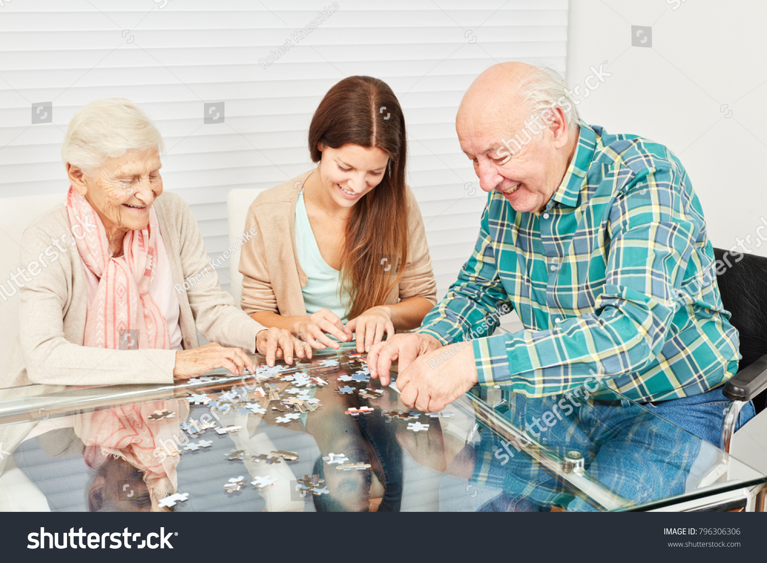 Family with seniors and granddaughter have fun playing puzzle at home #796306306