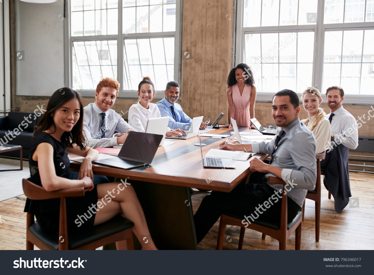 Black businesswoman and team at board meeting look to camera #796346017