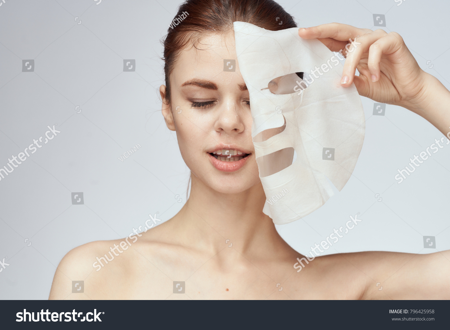   young beautiful woman in a face mask, skin care                              #796425958