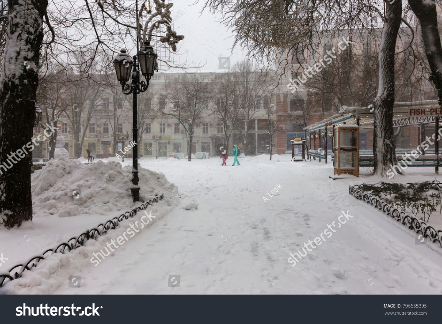 ODESSA, UKRAINE-January 16, 2018: Strong snowfall, cyclone in city streets in winter. Cars are covered with snow. Slippery road. Bad weather in winter: heavy snow and snowstorm. Pedestrians go on snow #796655395