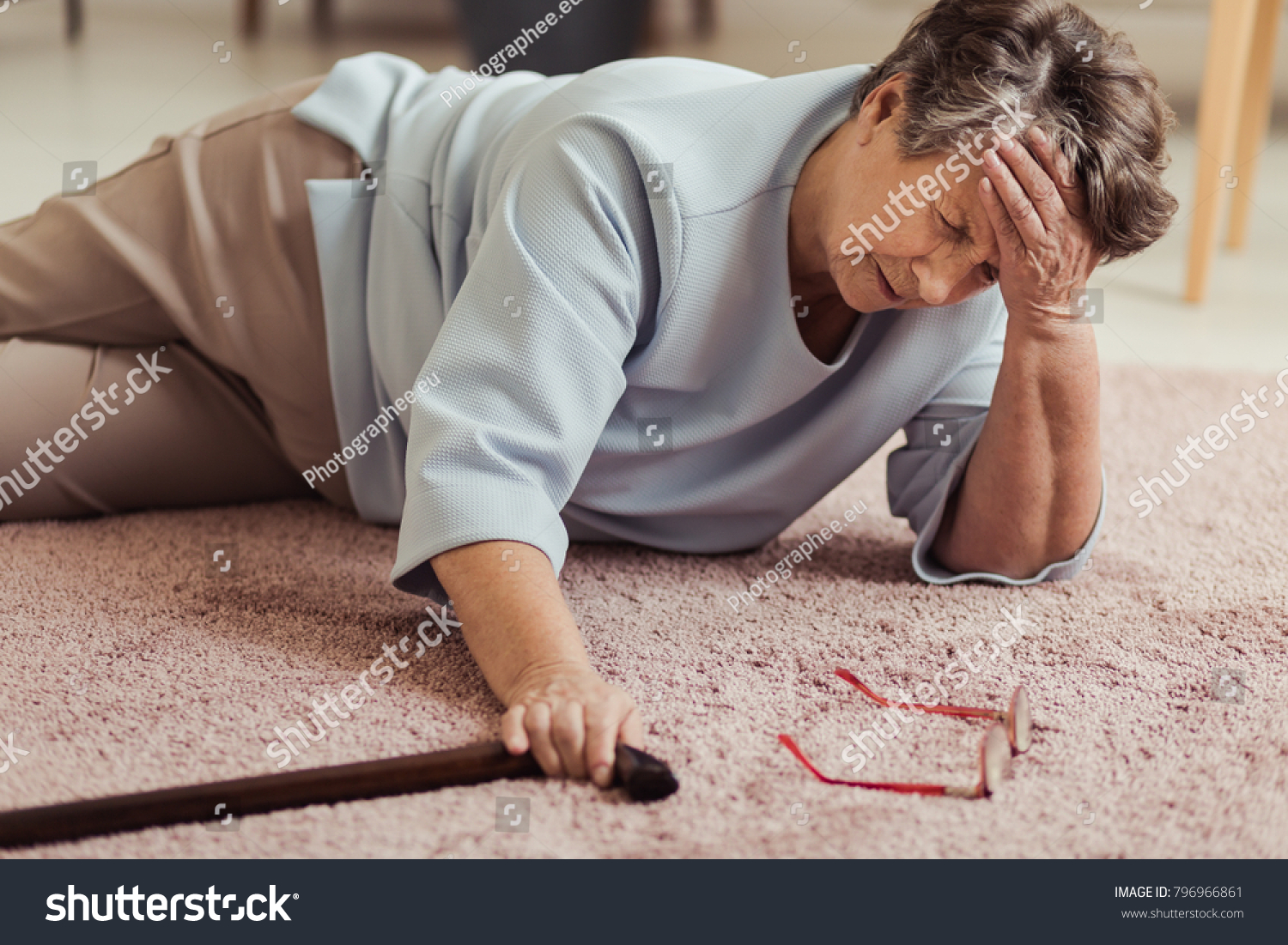 Sick senior woman with headache lying on the floor after falling down #796966861