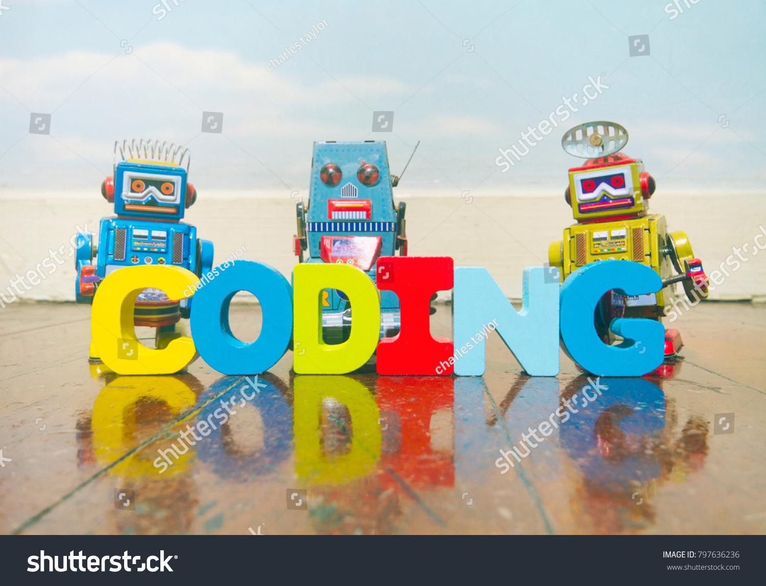 the word coding wit wooden letters on a old wooden floor with retro robot toys #797636236