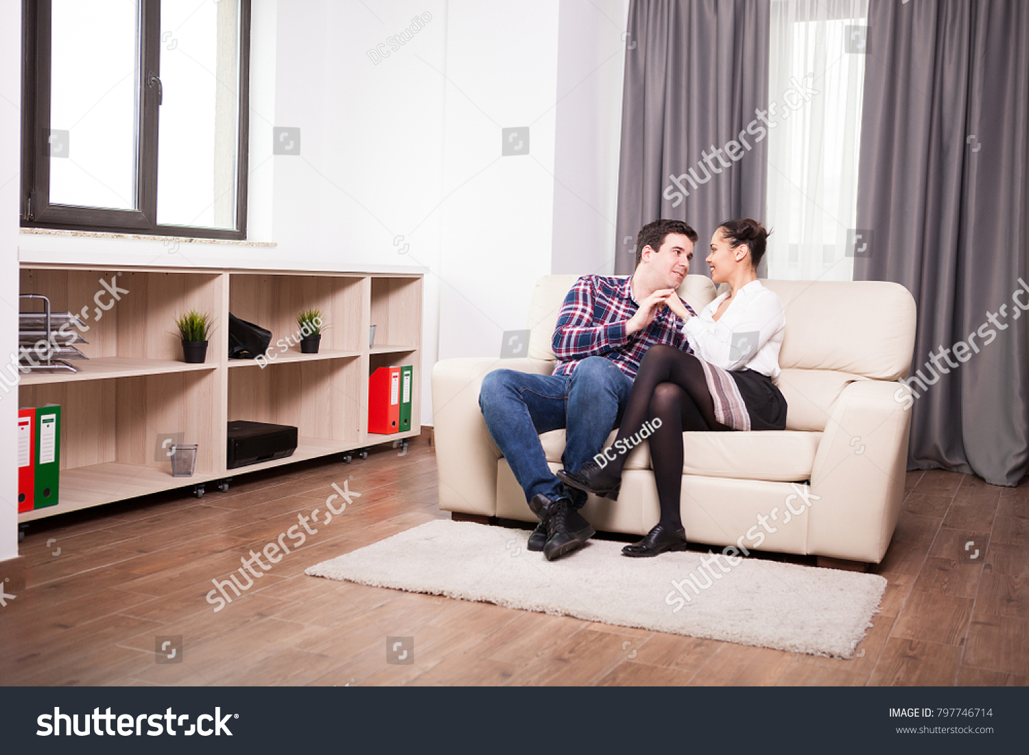 Couple spending time together in the living room. Love and relationship #797746714