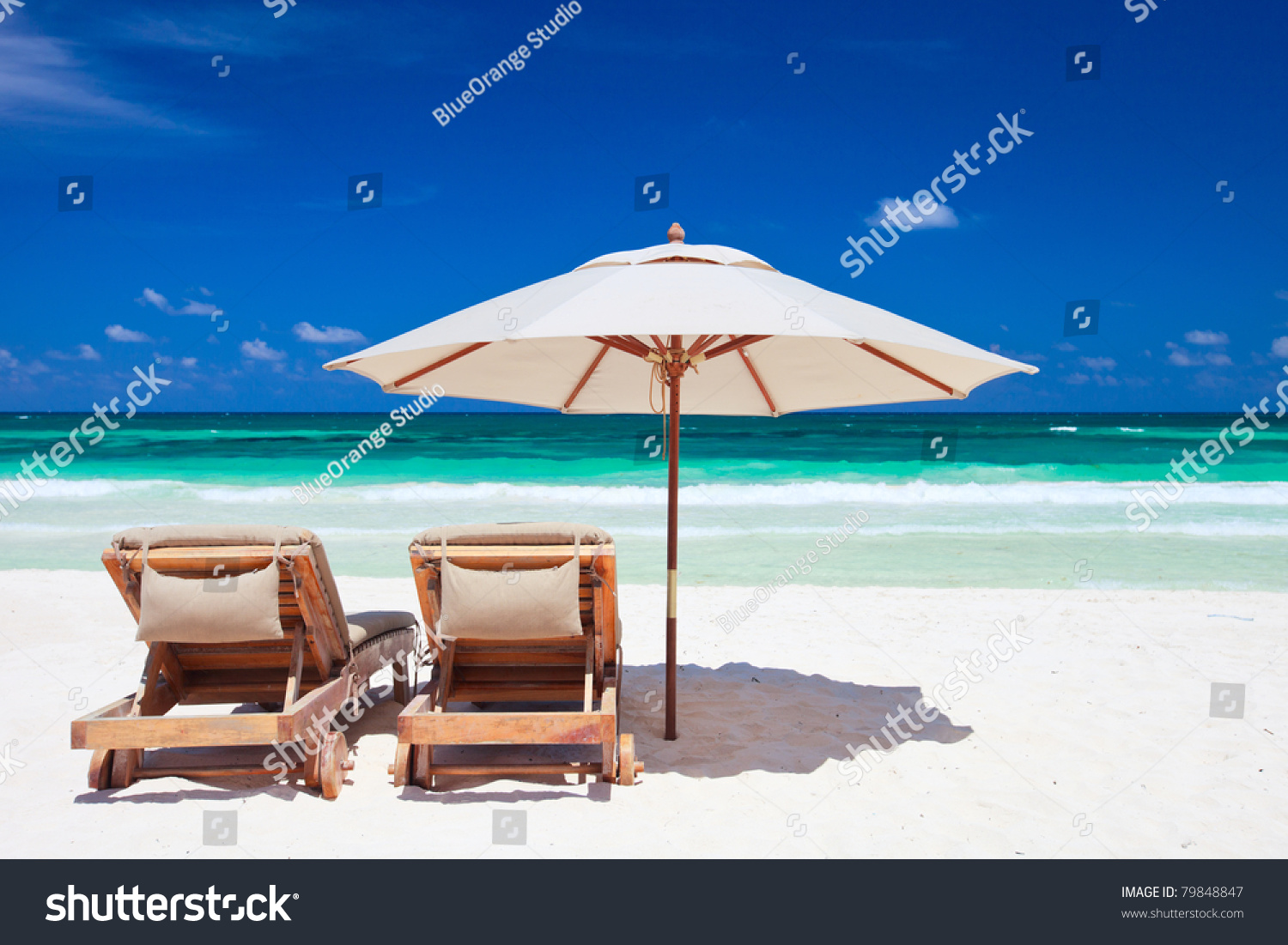Two chairs and umbrella on stunning tropical beach in Tulum, Mexico #79848847